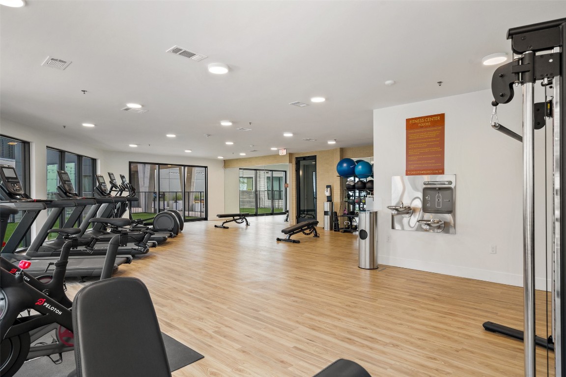 1701 Simond Avenue, Unit 206 Austin, TX 78723 - Photo 25 of 37 a view of a room with gym equipment and wooden floor