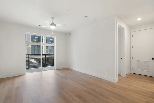 a view of a room with wooden floor