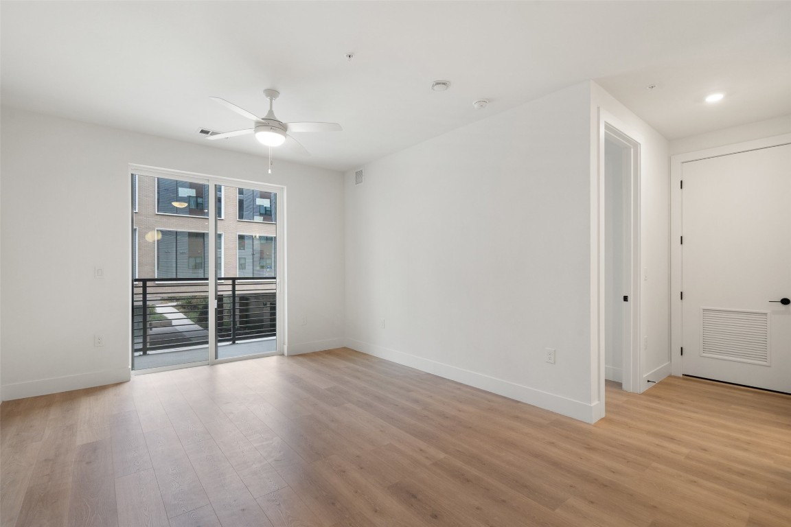 1701 Simond Avenue, Unit 206 Austin, TX 78723 - Photo 8 of 37 an empty room with wooden floor and cabinet