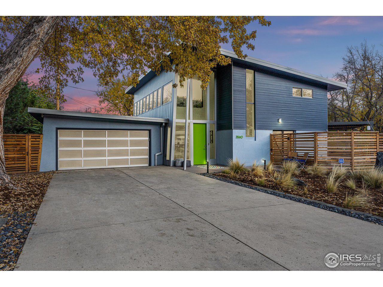 3560 9th Street Boulder, CO 80304 - Photo 9 of 39 a front view of a house with a yard and garage