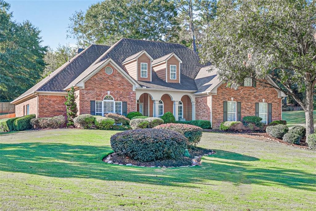 236 Reece Drive Hoschton, GA 30548 - Photo 1 of 58 a front view of a house with a garden