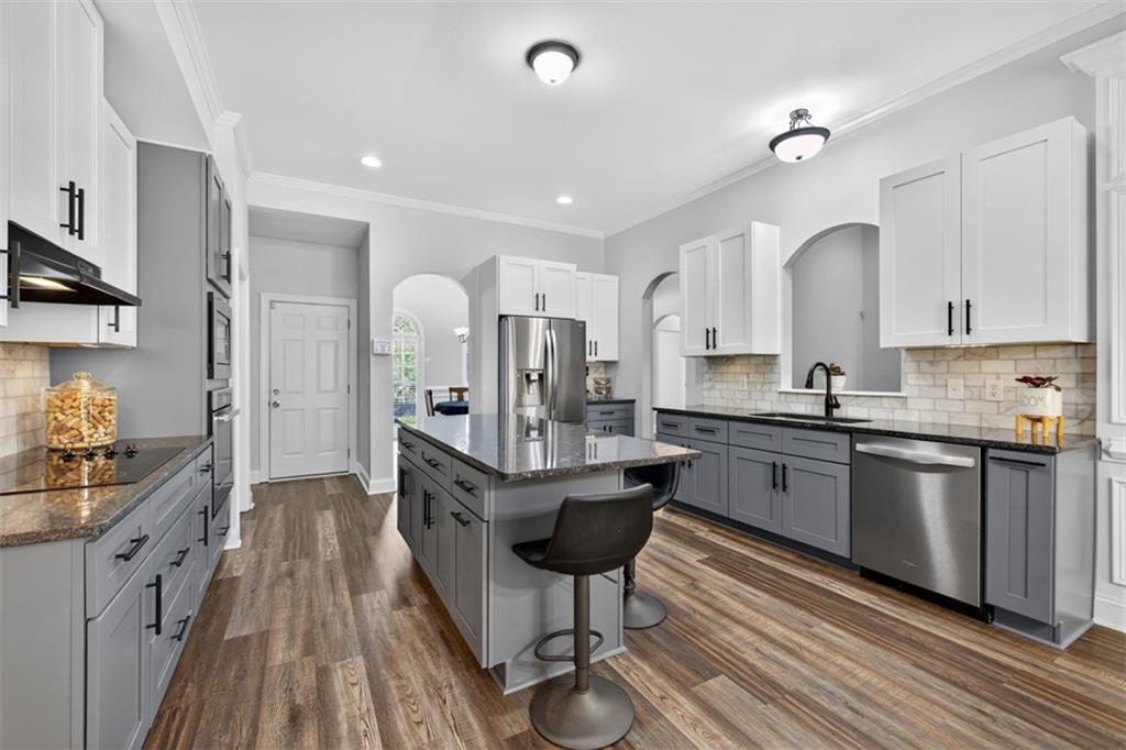 236 Reece Drive Hoschton, GA 30548 - Photo 11 of 58 a kitchen with granite countertop a sink appliances and cabinets