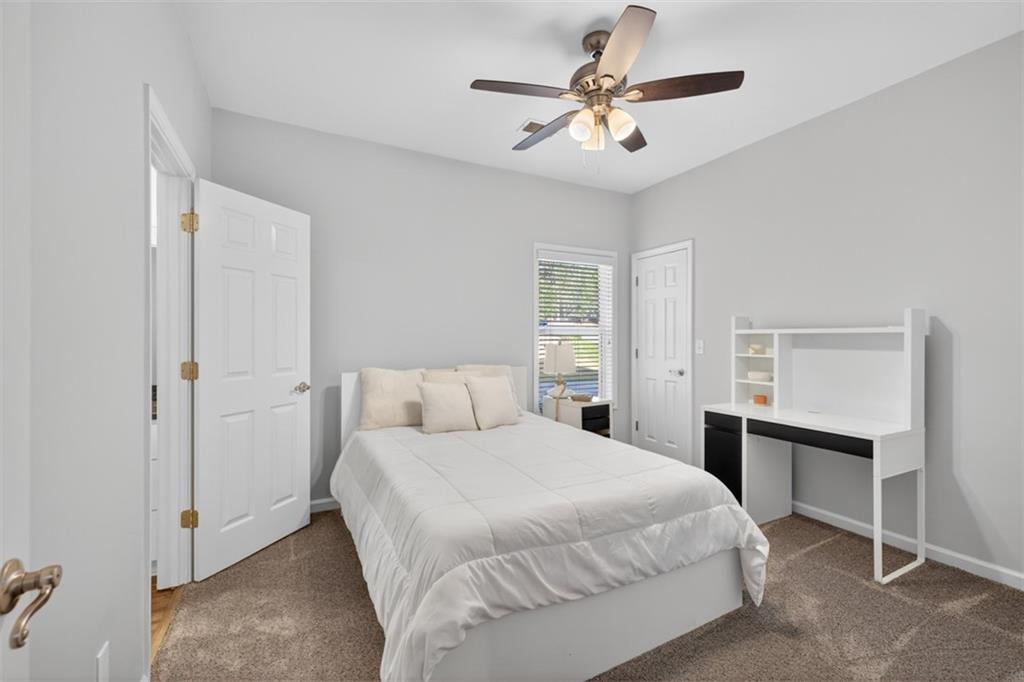 236 Reece Drive Hoschton, GA 30548 - Photo 20 of 58 a bedroom with a bed and a chandelier