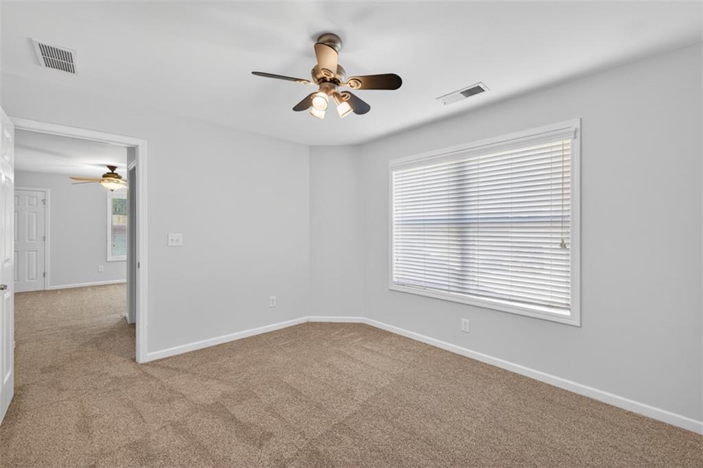 236 Reece Drive Hoschton, GA 30548 - Photo 29 of 58 a view of a livingroom with a ceiling fan and window