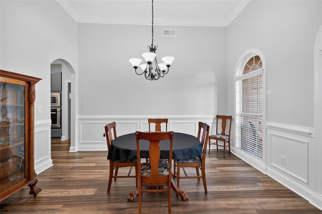 236 Reece Drive Hoschton, GA 30548 - Photo 51 of 58 a view of a dining room with furniture a chandelier and wooden floor