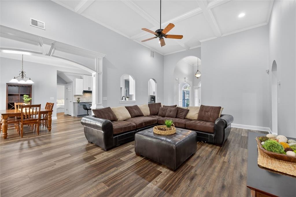 236 Reece Drive Hoschton, GA 30548 - Photo 54 of 58 a living room with furniture kitchen view and a wooden floor