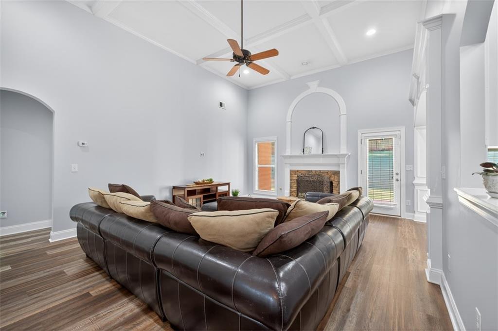 236 Reece Drive Hoschton, GA 30548 - Photo 9 of 58 a living room with furniture a fireplace and a wooden floor