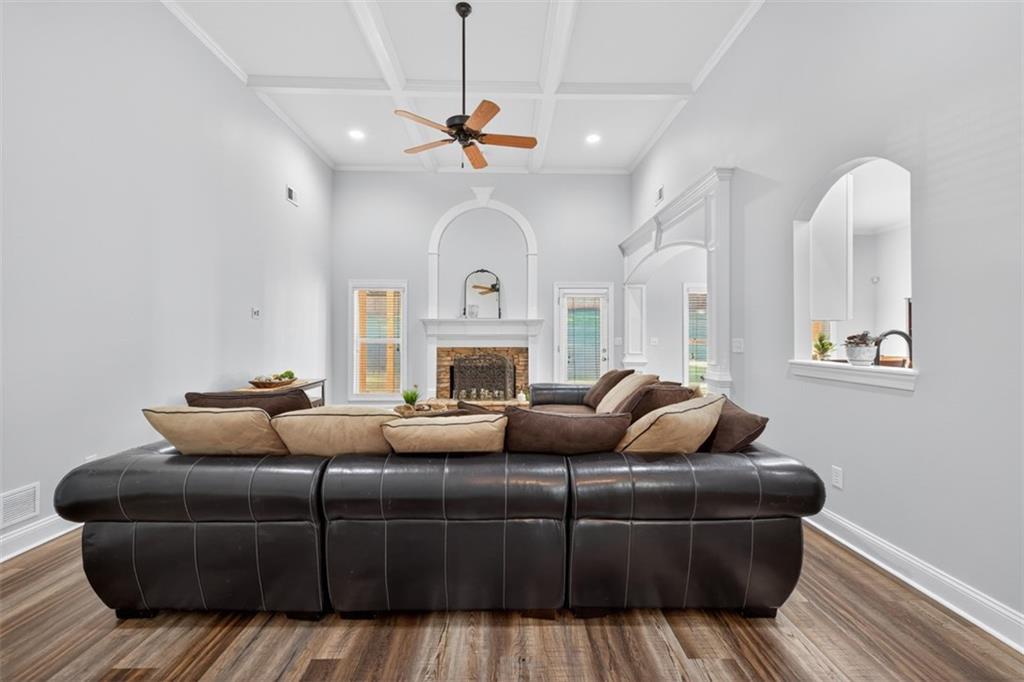 236 Reece Drive Hoschton, GA 30548 - Photo 10 of 58 a living room with furniture a fireplace and a chandelier