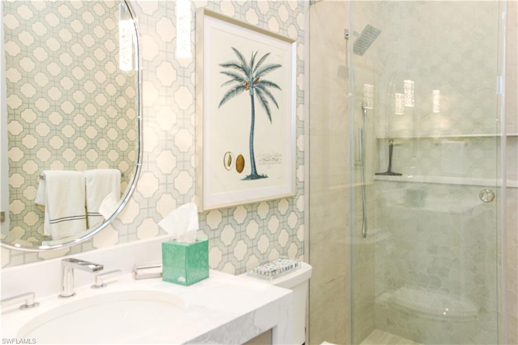 3123 Crayton Road Naples, FL 34103 - Photo 11 of 50 a bathroom with a sink and a mirror