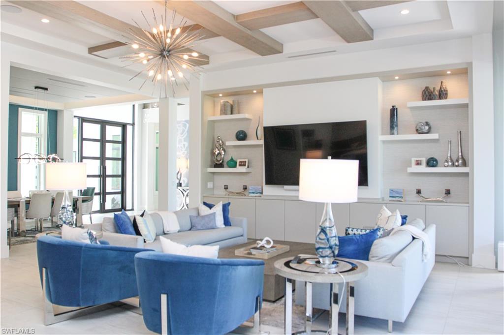 3123 Crayton Road Naples, FL 34103 - Photo 17 of 50 a living room with furniture and a flat screen tv