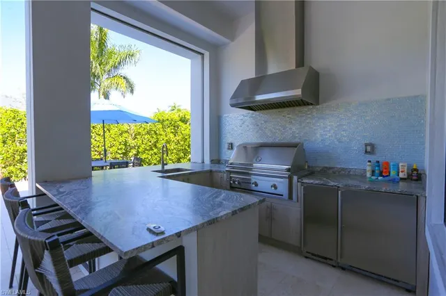 a kitchen with a table chairs and a window