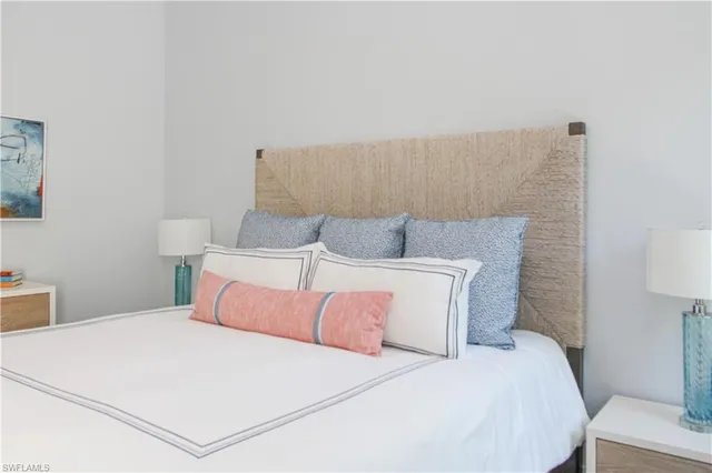 a bedroom with a bed and a lamp