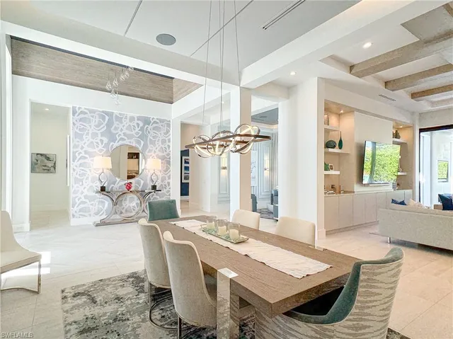 a living room with furniture a table and wooden floor