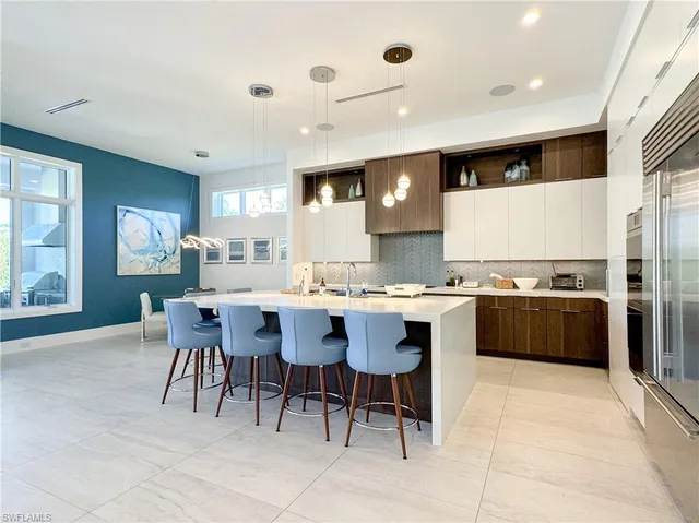 a large kitchen with a table and chairs