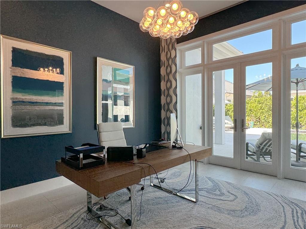 3123 Crayton Road Naples, FL 34103 - Photo 34 of 50 a living room with furniture and a chandelier