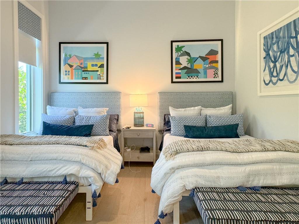 3123 Crayton Road Naples, FL 34103 - Photo 41 of 50 a bedroom with bed a painting on the wall and a large window