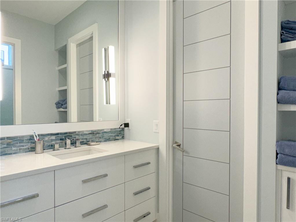3123 Crayton Road Naples, FL 34103 - Photo 42 of 50 a bathroom with a sink and a mirror