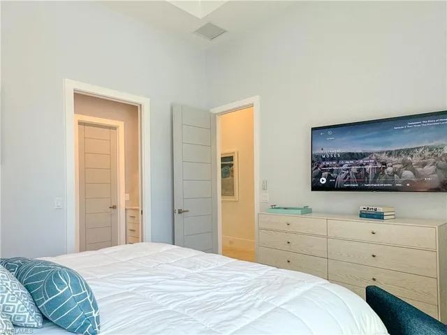 a bedroom with a bed and a dresser in it