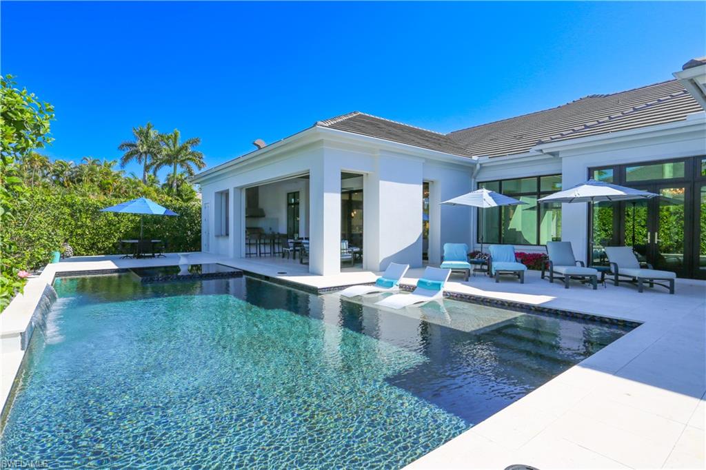 3123 Crayton Road Naples, FL 34103 - Photo 6 of 50 a view of a house with backyard porch and patio