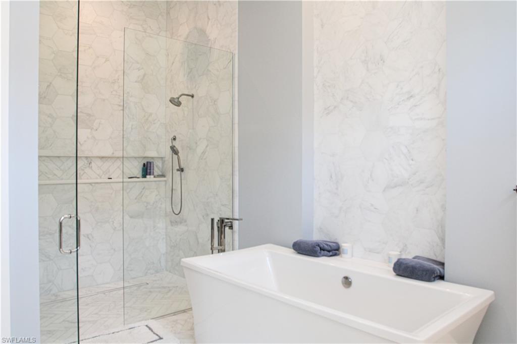 3123 Crayton Road Naples, FL 34103 - Photo 8 of 50 a bathroom with a white bath tub
