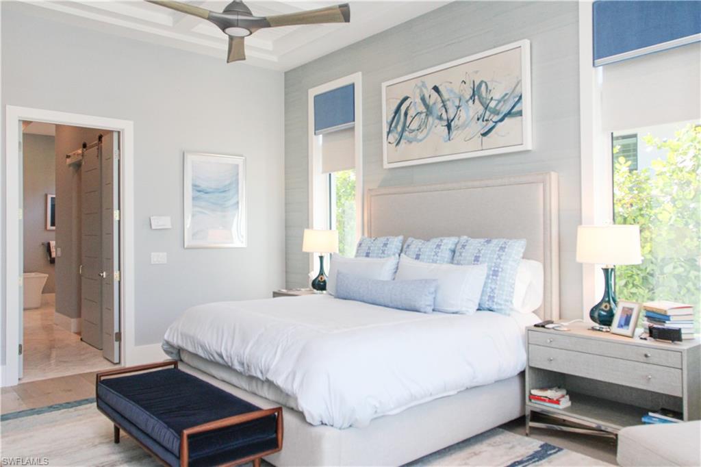 3123 Crayton Road Naples, FL 34103 - Photo 10 of 50 a bedroom with a large bed and a couch