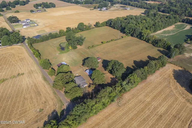 an aerial view of a house a yard and lake view