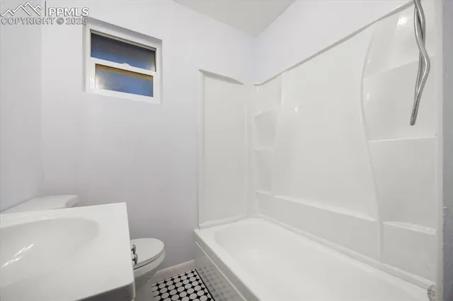 a bathroom with a shower and a toilet