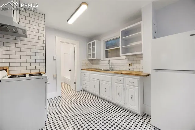 a kitchen with a sink stove and cabinets