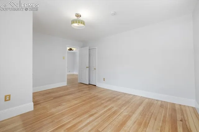 a view of a room with wooden floor and a sink