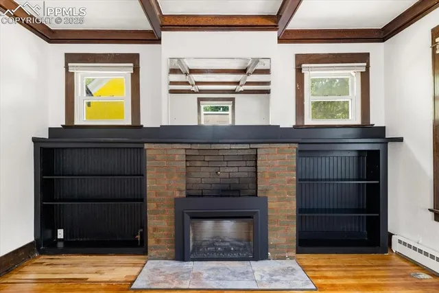 a living room with a fireplace and a window