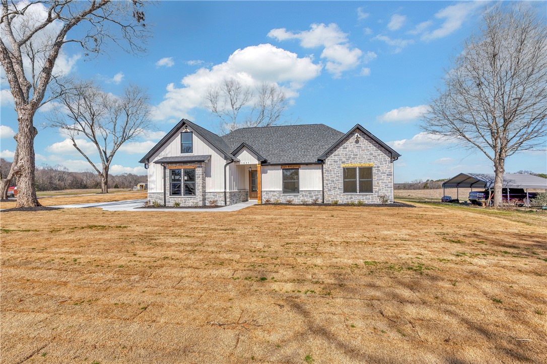 2816 Smith McGee Road Iva, SC 29655 - Photo 3 of 25 Crafted with elegant stone and siding, this new construction home boasts a welcoming facade set against a sprawling rural backdrop.