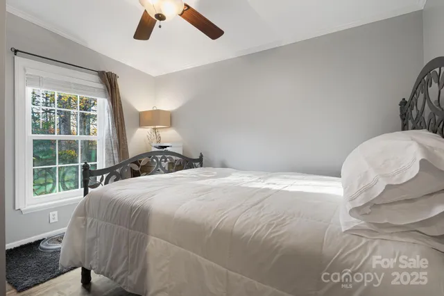 a bedroom with a bed and a large window