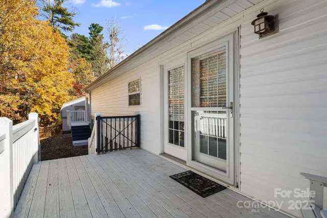 a view of a house with a wooden deck