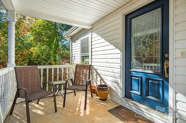 a view of a two chairs and table in the balcony
