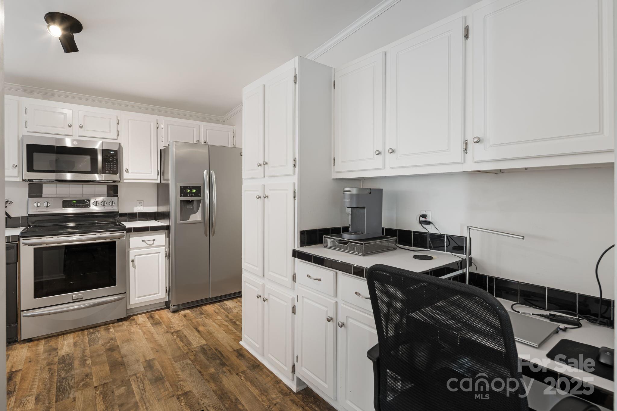 57 Founders Way Arden, NC 28704 - Photo 7 of 26 a kitchen with granite countertop a stove sink and refrigerator