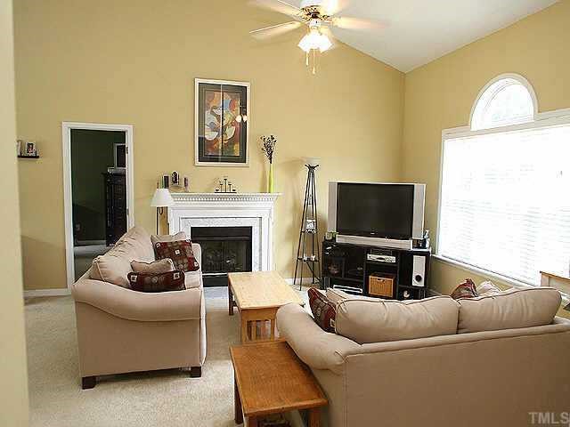 6424 Tinderbox Lane Raleigh, NC 27603 - Photo 5 of 10 Sunny and bright living room with cathedral ceiling, paladium window and gas log fireplace!