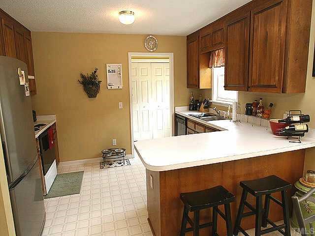 6424 Tinderbox Lane Raleigh, NC 27603 - Photo 10 of 10 Great kitchen with lots of cabinets and breakfast bar! Note the separate laundry room!