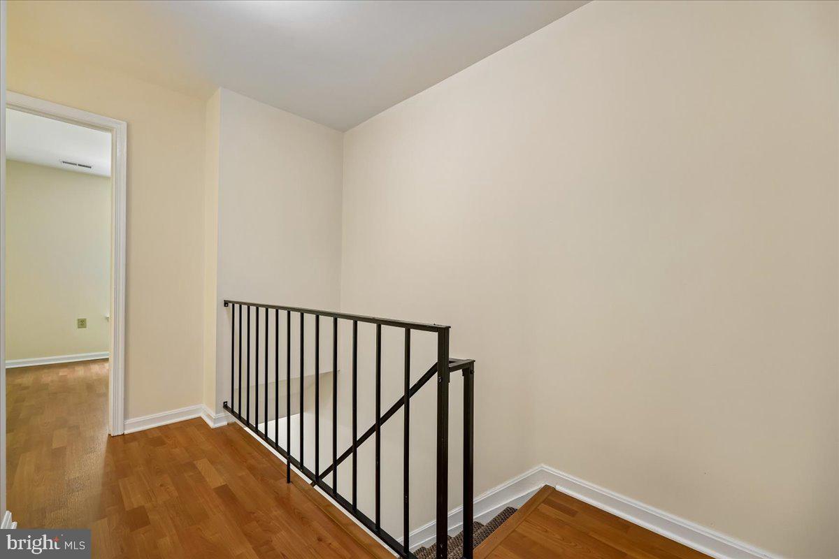 18012 Golden Spring Court, Unit 239 Olney, MD 20832 - Photo 19 of 44 a view of a hallway with wooden floor and a bathroom