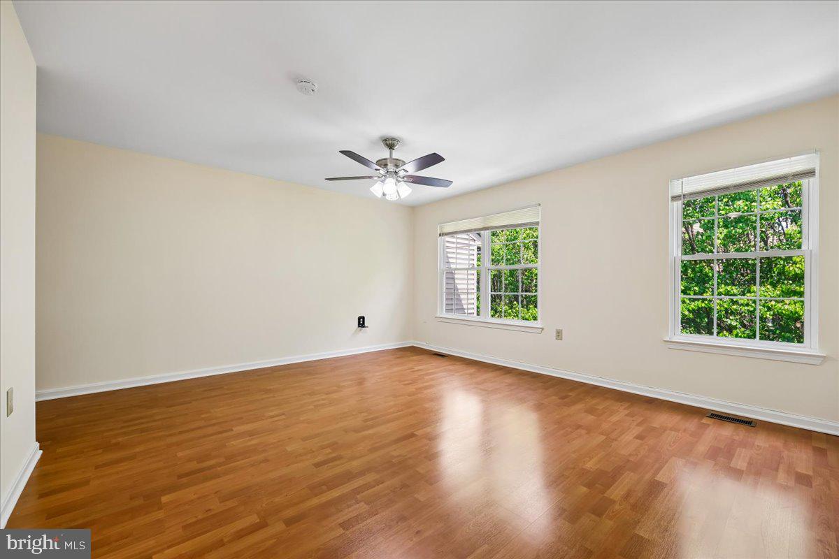 18012 Golden Spring Court, Unit 239 Olney, MD 20832 - Photo 23 of 44 wooden floor in an empty room with a window