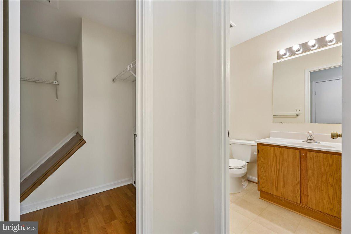 18012 Golden Spring Court, Unit 239 Olney, MD 20832 - Photo 25 of 44 a bathroom with a sink mirror vanity and toilet