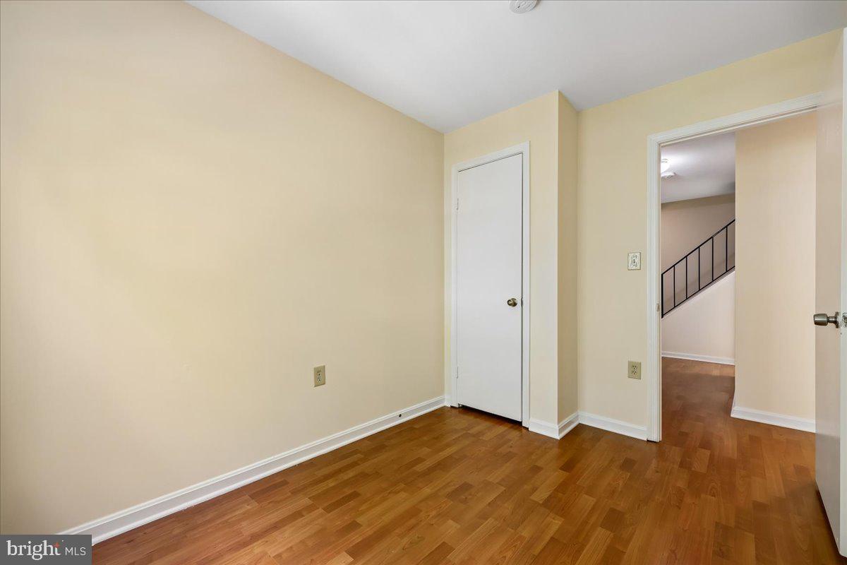 18012 Golden Spring Court, Unit 239 Olney, MD 20832 - Photo 28 of 44 a view of empty room with wooden floor and fan