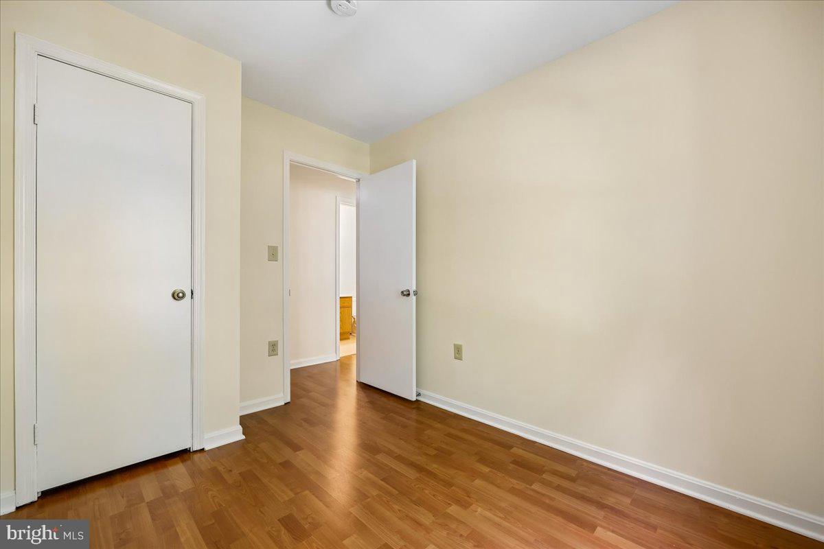 18012 Golden Spring Court, Unit 239 Olney, MD 20832 - Photo 29 of 44 a view of an empty room with wooden floor
