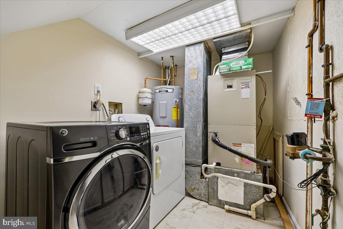 18012 Golden Spring Court, Unit 239 Olney, MD 20832 - Photo 39 of 44 a utility room with dryer and washer