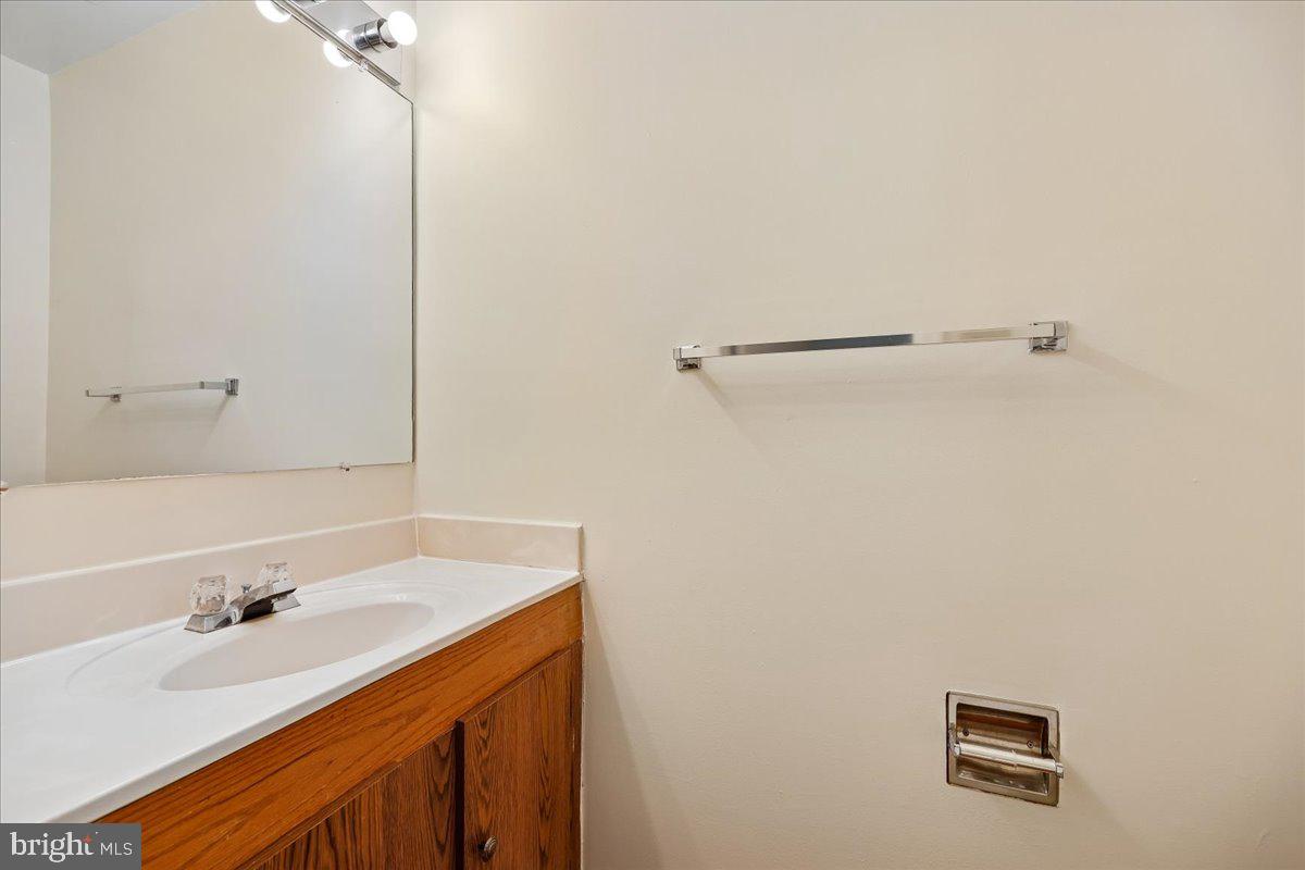 18012 Golden Spring Court, Unit 239 Olney, MD 20832 - Photo 40 of 44 a bathroom with a sink and a mirror