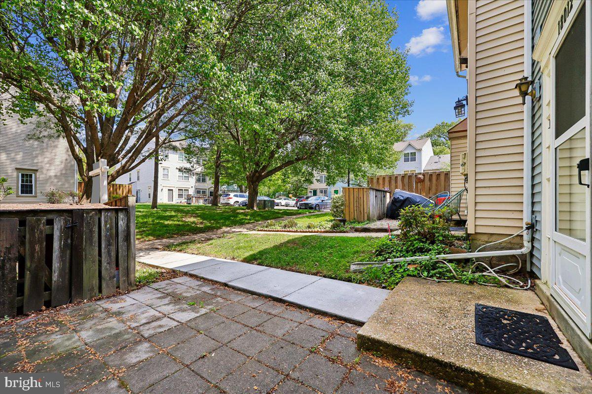 18012 Golden Spring Court, Unit 239 Olney, MD 20832 - Photo 7 of 44 a view of a garden with plants and large trees