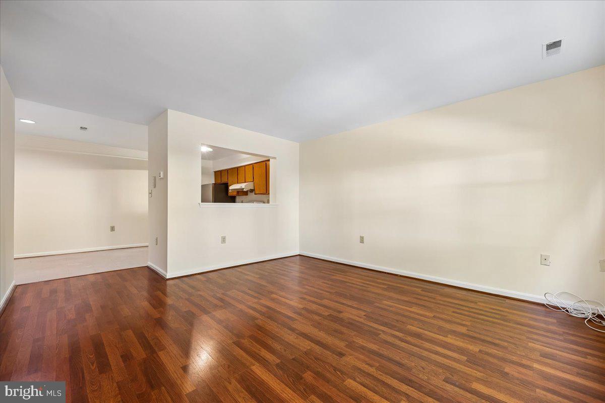 18012 Golden Spring Court, Unit 239 Olney, MD 20832 - Photo 9 of 44 a view of a room with wooden floor and white walls