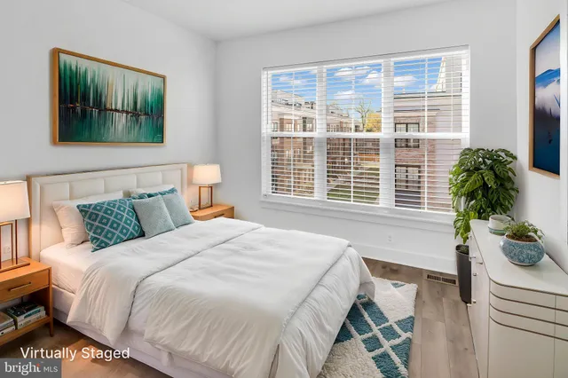 a bedroom with a bed and a potted plant