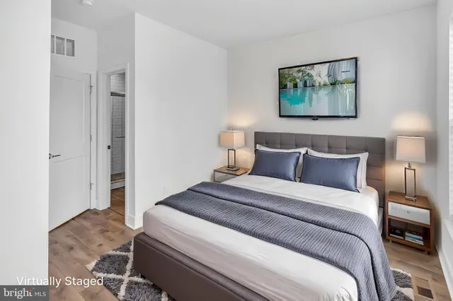 a bedroom with a bed and a painting on the wall