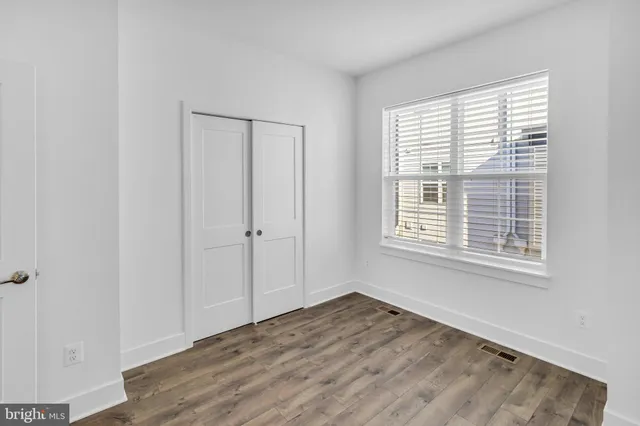 a bedroom with a bed and a potted plant