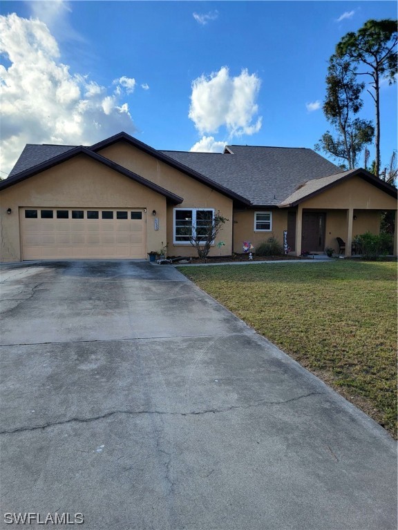 17520 Braddock Road Fort Myers, FL 33967 - Photo 1 of 31 a front view of a house with a garden and yard